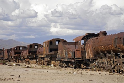 Rusty locomotive engines at cemetery of trains near Uyuni
