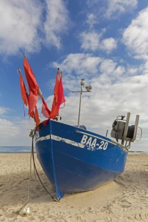 Blue fishing boat on the beach along the Baltic Sea at Baabe on the Island Ruegen