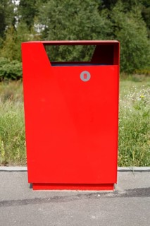 Red metal public waste bin