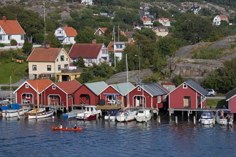 Red wooden boat huts in the harbour at Hamburgsund