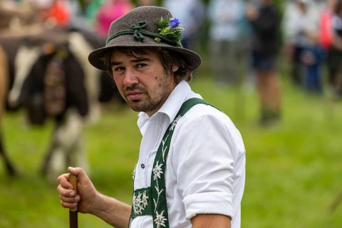 Alpine herdsman on the pasture
