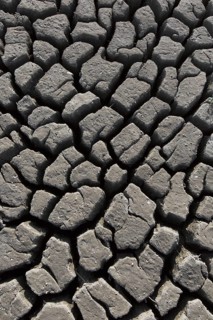Abstract pattern of dry cracked clay mud in dried up lake bed