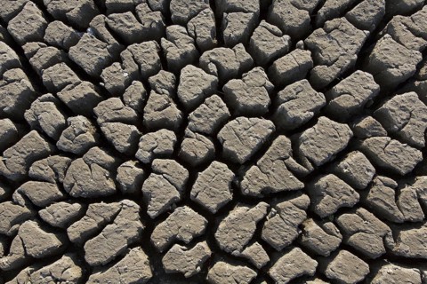 Abstract pattern of dry cracked clay mud in dried up lake bed