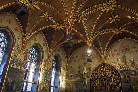 Interior of the city hall of Bruges showing the Gothic hall with polychrome vault and 19th century murals