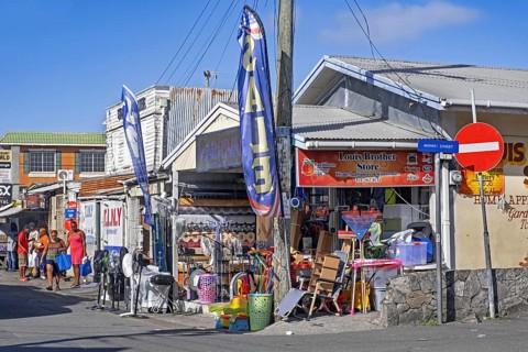 Streetscene showing local black people and shops at St. John's