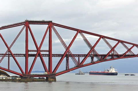 Oil tanker sailing under the Forth Railway Bridge