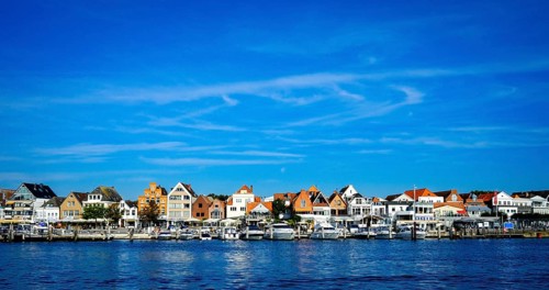 Front row commercial buildings and gastronomy in Travemuende on the river Trave. Hanseatic City of Luebeck. Schleswig-Holstein. Germany