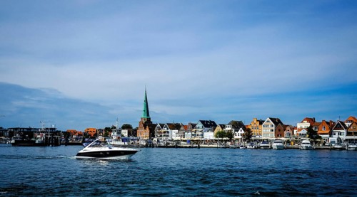 Trave with front rows of houses in Travemuende at the harbour. Hanseatic City of Luebeck