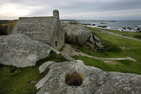 Old customs house wedged between the rocks at Menez Ham