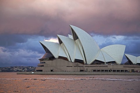 Heavy rain clouds and approaching thunderstorm over the Sydney Opera House at sunset