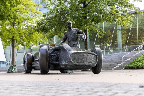 Monument in front of the Mercedes-Benz Museum commemorates the legendary racing driver Juan Manuel Fangio in his 1954 Silver Arrow W 196 R