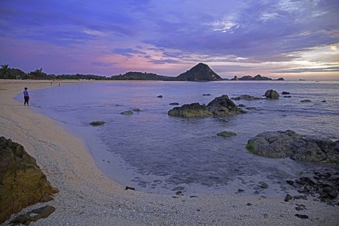 Tourists on Kuta beach at sunset on the island Lombok
