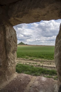 View over the Waterloo battlefield and the Lion Hill seen through loophole in the garden wall of the Chateau d'Hougoumont