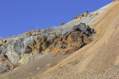 Volcanic rock formations and sulphur coloured rhyolite mountain at Brennisteinsalda volcano near Landmannalaugar