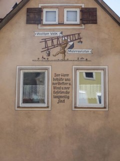 Fresco with motto on house facade