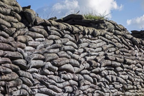 Wall of stacked sandbags in WWI trench used as defence in First World War One warfare