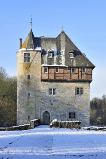 13th Century keep of Castle Carondelet at Crupet in the snow in winter