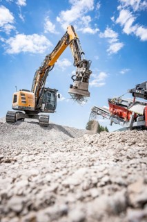 Yellow tracked excavator for demolition recycling on construction site