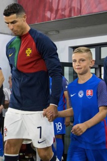 Cristiano RONALDO Portugal with proud Slovakian boy entering the pitch together