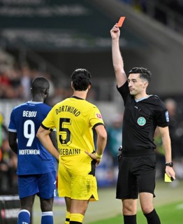 Referee Florian Badstuebner shows Ramy Bensebaini Borussia Dortmund BVB