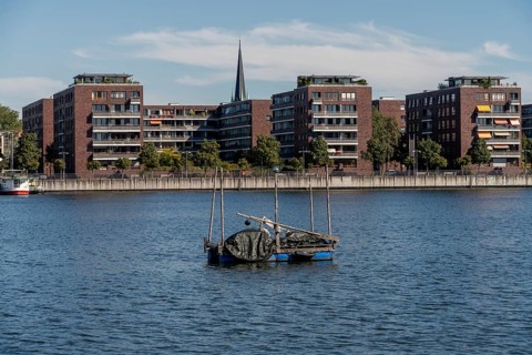 Illegally anchored houseboats in the Rummelsburg Bay with the residential houses on the Rummelsburg shore