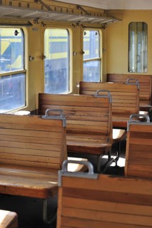 Old passenger carriage with wooden benches at the depot of the Chemin de Fer a Vapeur des Trois Vallees at Mariembourg