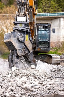 Yellow Liebherr crawler excavator recycling on demolition site