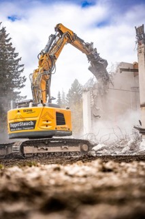 Yellow Liebherr crawler excavator recycling on demolition site