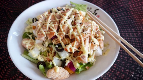 Overhead close up to a classic chicken salad with olives and crouton