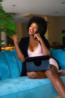 Young entrepreneur of black race and afro hair making a video call very happy