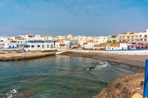 View from above of the black beach of the tourist town of El Cotillo in the north of the island of Fuerteventura