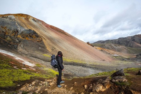 A young woman on the red mountain of the 54 km trek from Landmannalaugar