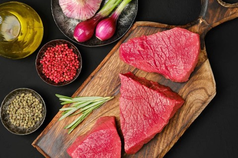 Flat lay composition with raw beef strip steak boneless