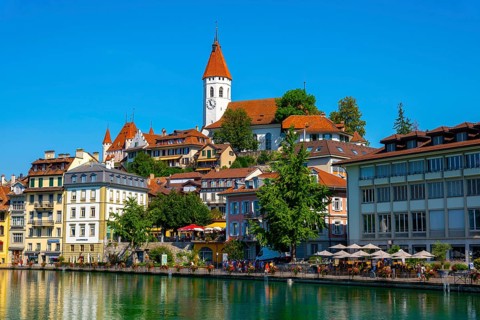 City of Thun and River Aare with Castle and Church in a Sunny Day in Thun