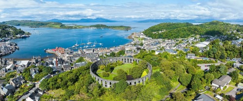Aerial panorama of the harbour town of Oban with McCaig's Tower