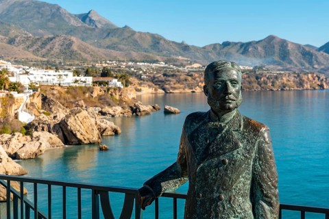 Sculpture on the Balcon de Europa and Calahonda beach in the background of the town of Nerja