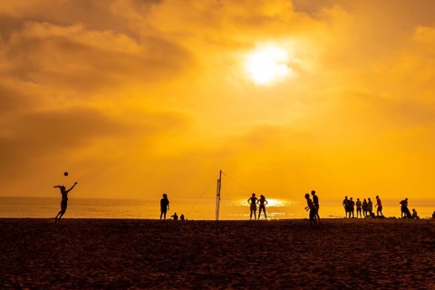 Some young people playing volleyball on the beach of San Miguel in the city of Almeria