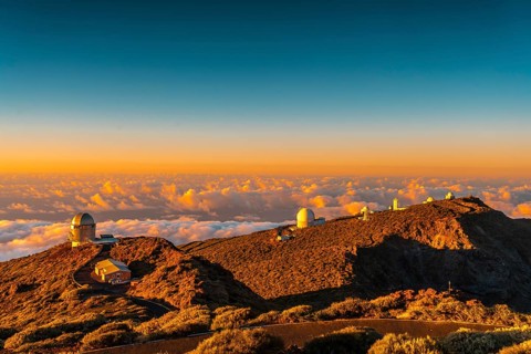 Observatories of Roque de los Muchachos in the Caldera de Taburiente in a beautiful orange sunset