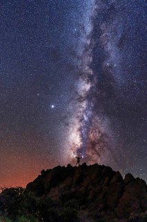 A young woman below the beautiful lactea way of the Caldera de Taburiente near the Roque de los Muchahos on the island of La Palma