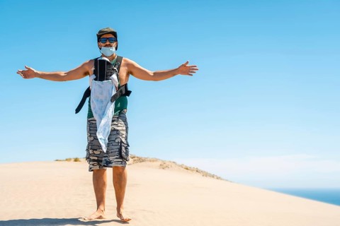 A young man enjoying the holidays with his son on the sand dune at Monsul beach in the Cabo de Gata Natural Park