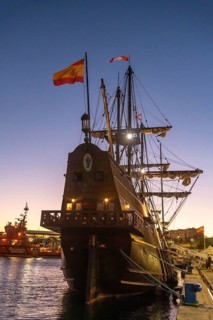 Old boat at sunset on the promenade of Muelle Uno in the Malagaport of the city of Malaga