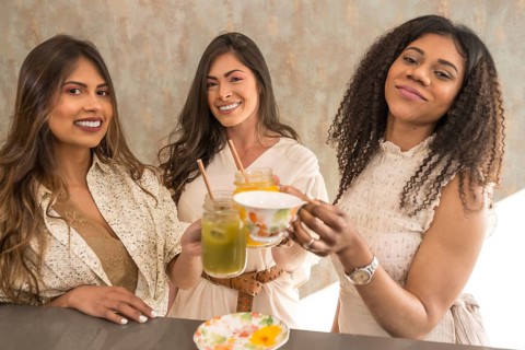 Woman toasting and celebrating with juices and tea