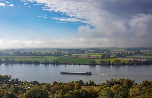 Cargo ship in the morning mist on the Danube near Regensburg