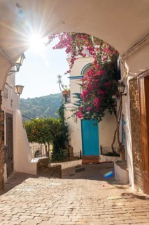 The city gate of Mojacar with white houses on top of the mountain. Costa Blanca in the Mediterranean Sea
