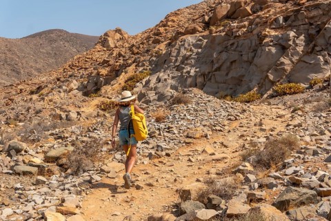 A young woman walking along the canyon path towards the Mirador de la Penitas