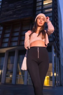 A young brunette Caucasian posing in the city on a winter night