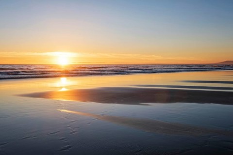 Atlantic ocean sunset with surging waves at Fonte da Telha beach