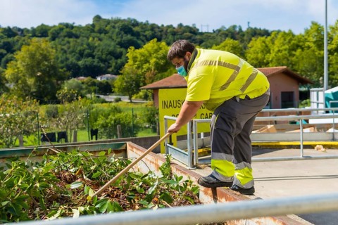 Worker in a recycling factory or clean point and garbage with a face mask and with security protections