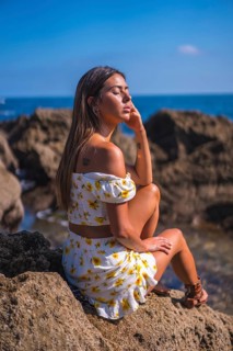 Portrait of a young woman in a white dress on the beach