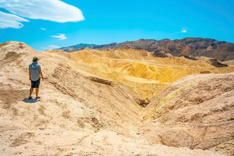 Panoramic of a young man enjoying the view of the Zabriskie Point viewpoint